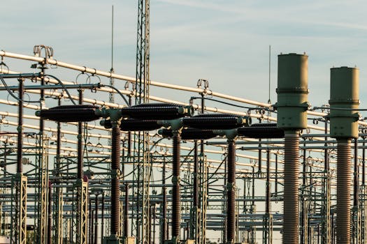 pexels-photo-36137497-36137497 Detailed view of electrical substation with high voltage equipment and insulators against a clear sky.